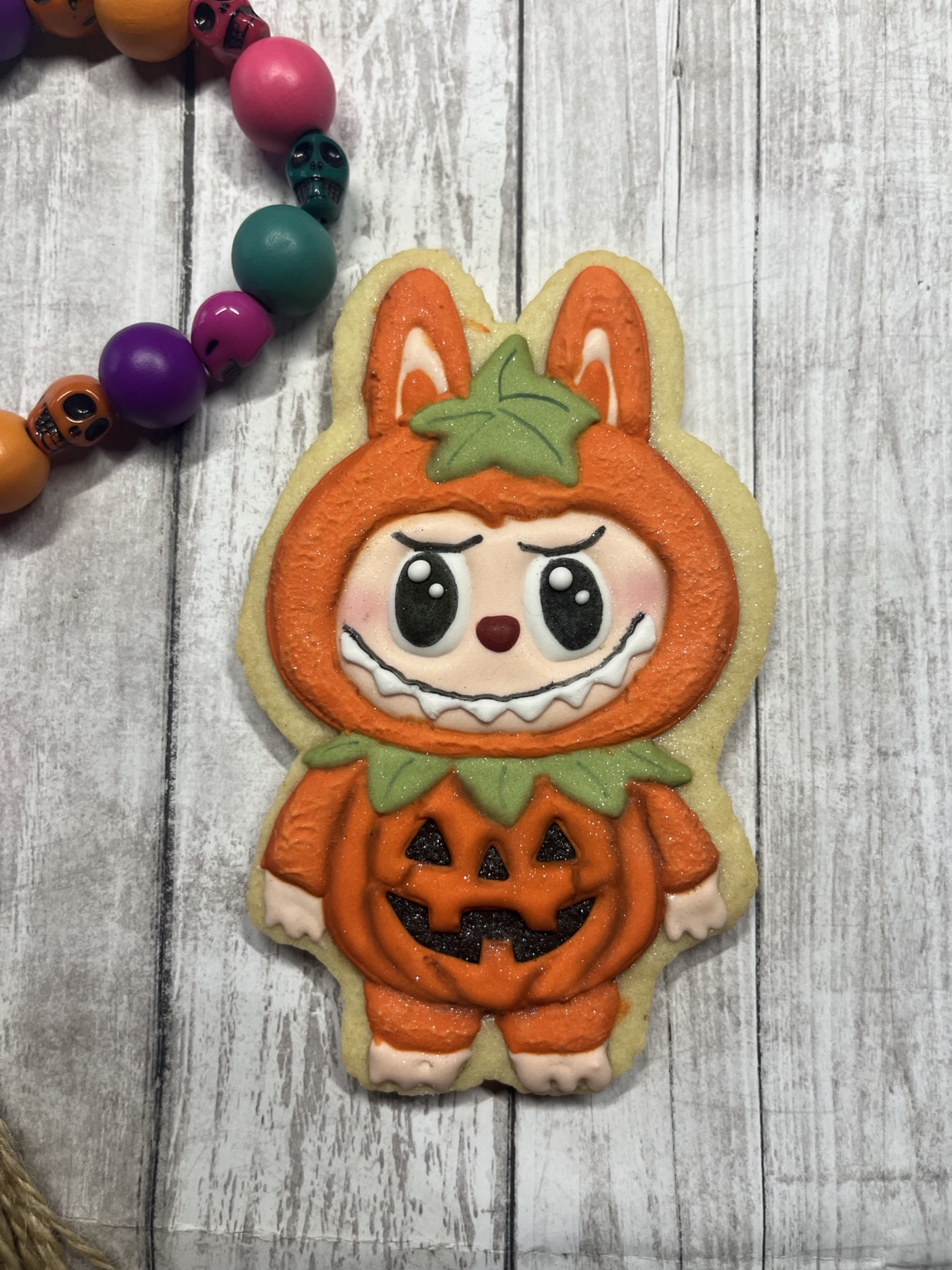Pumpkin-costume character cookie